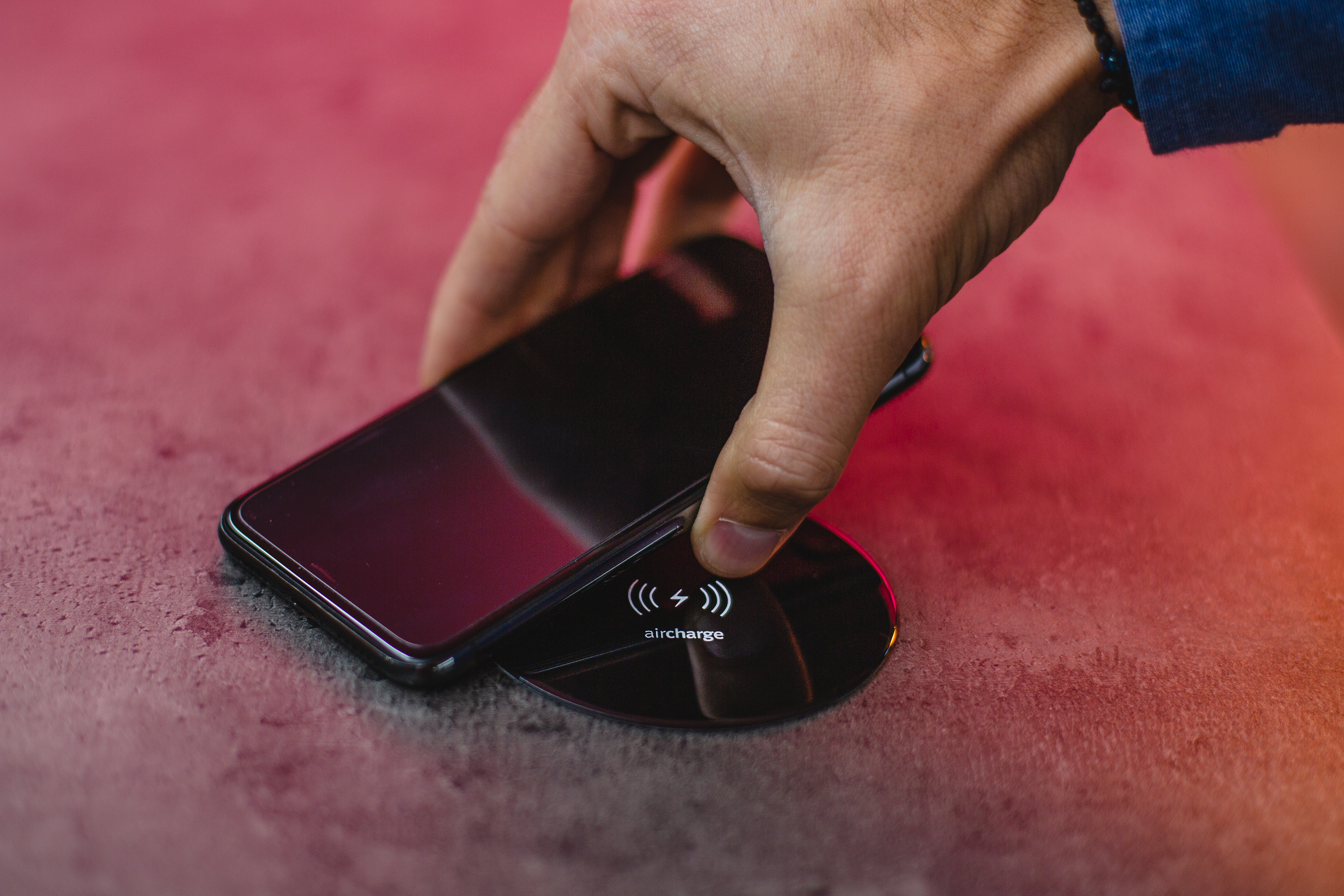 Hand placing phone on charger